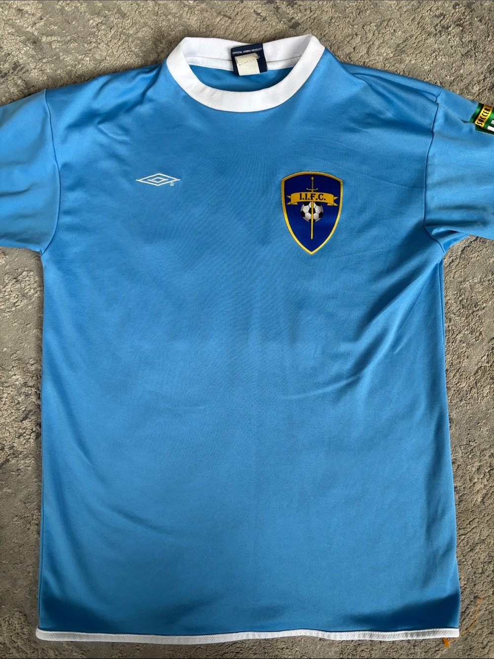 Vintage UMBRO Light Blue Soccer Jersey with Crest by Umbro